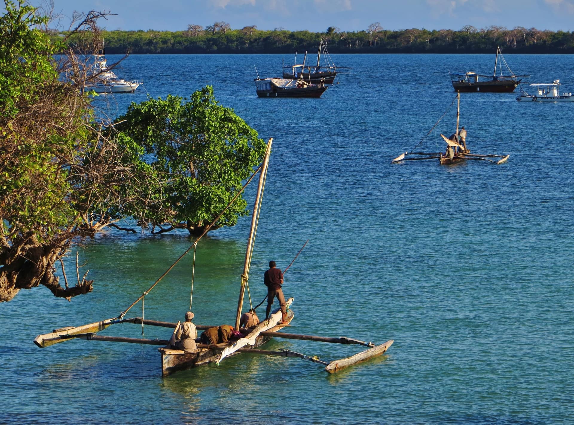 Fishermen on a traditional outrigger boat near Shimoni