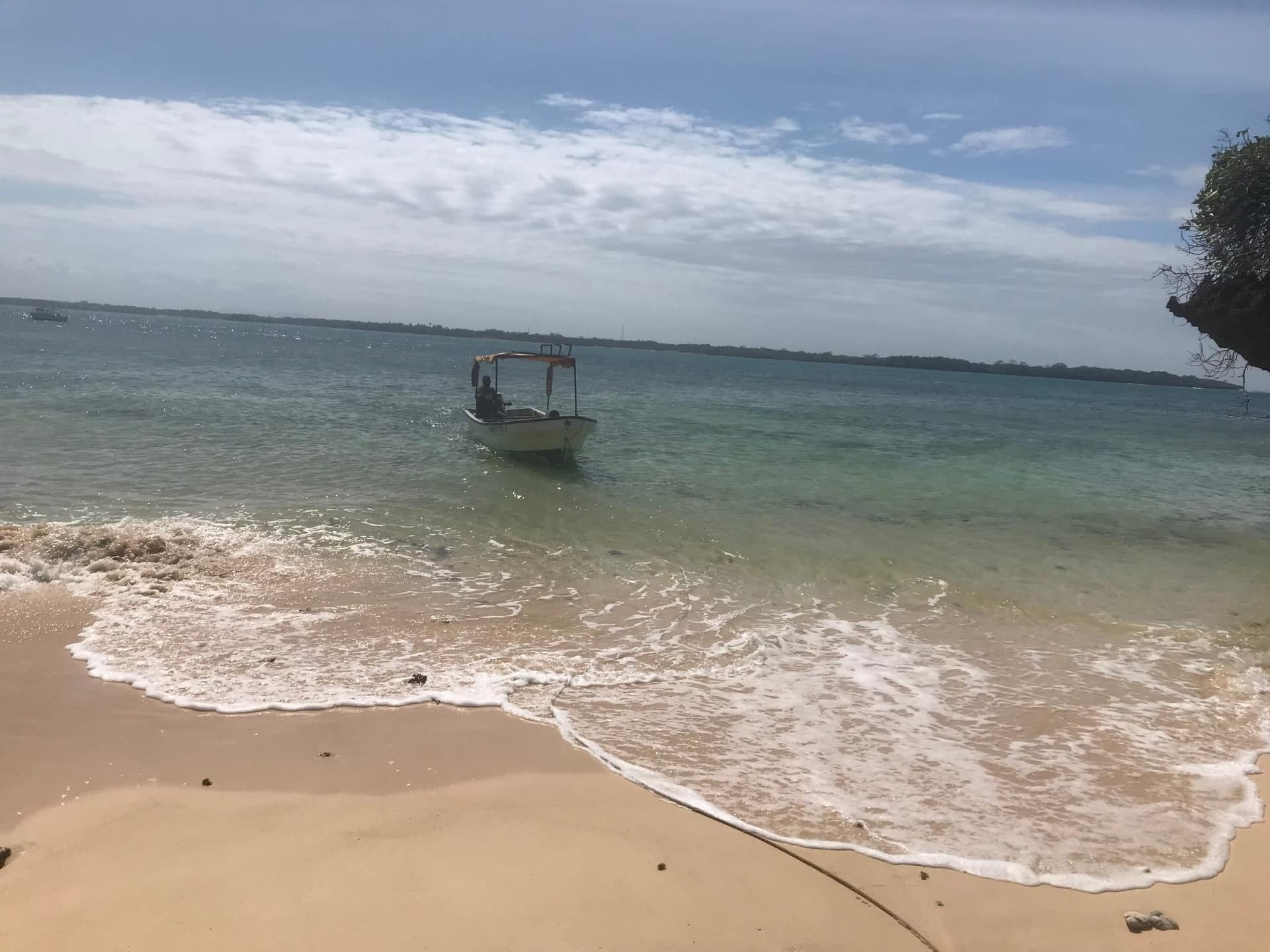 A small boat in clear, shallow water off Wasini Island